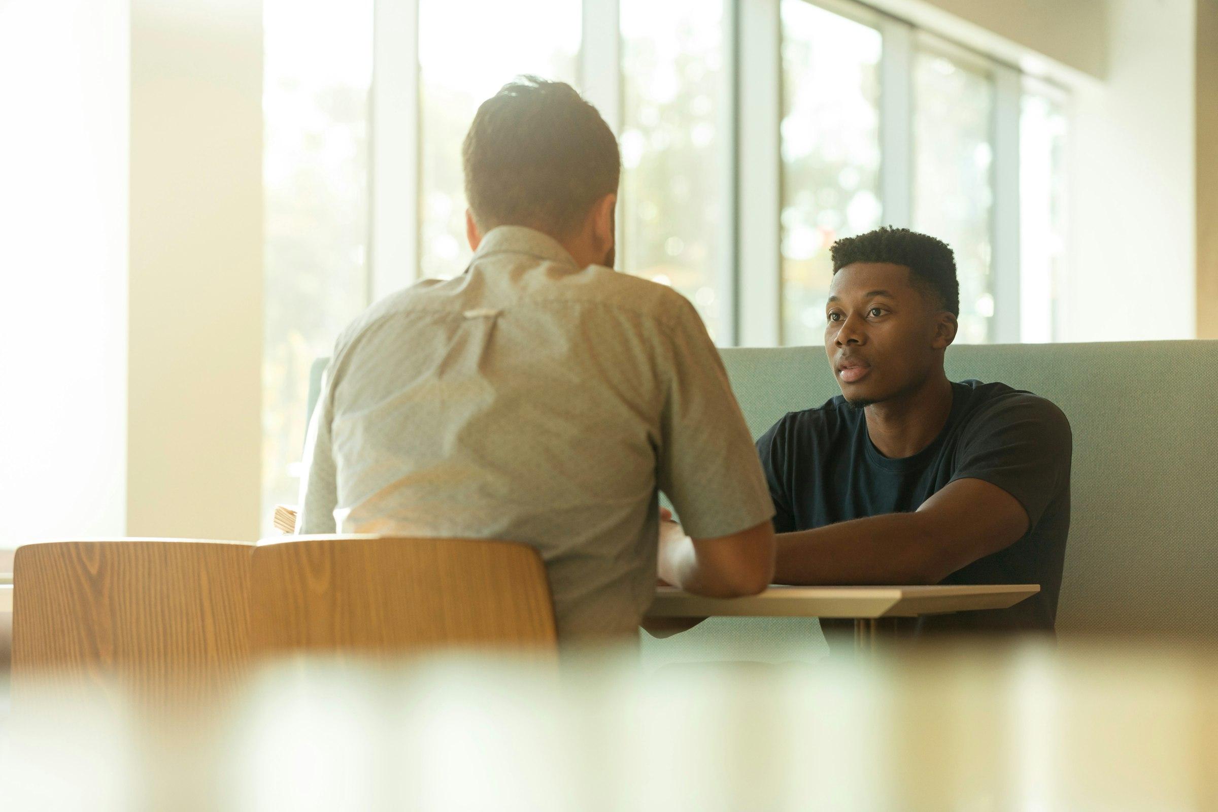 A client in a counseling conversation, facing the counselor